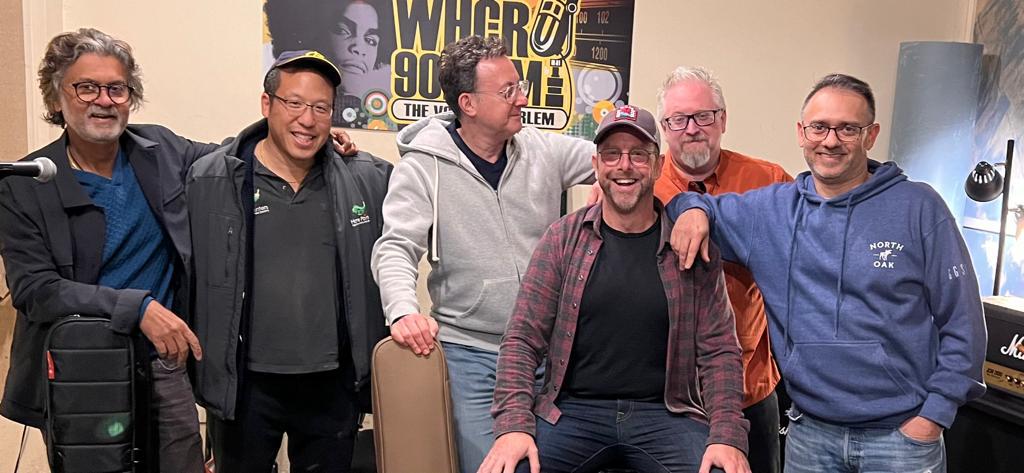 crowd enjoying small concert under red lighting